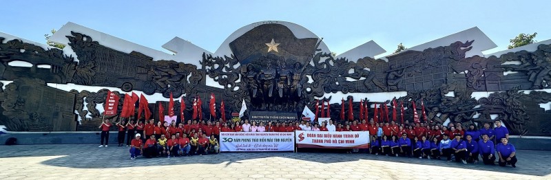 Đoàn diễu hành chụp hình kỷ niệm trước đài tưởng niệm khu truyền thống cuộc Tổng tiến công và nổi dậy Xuân Mậu Thân 1968